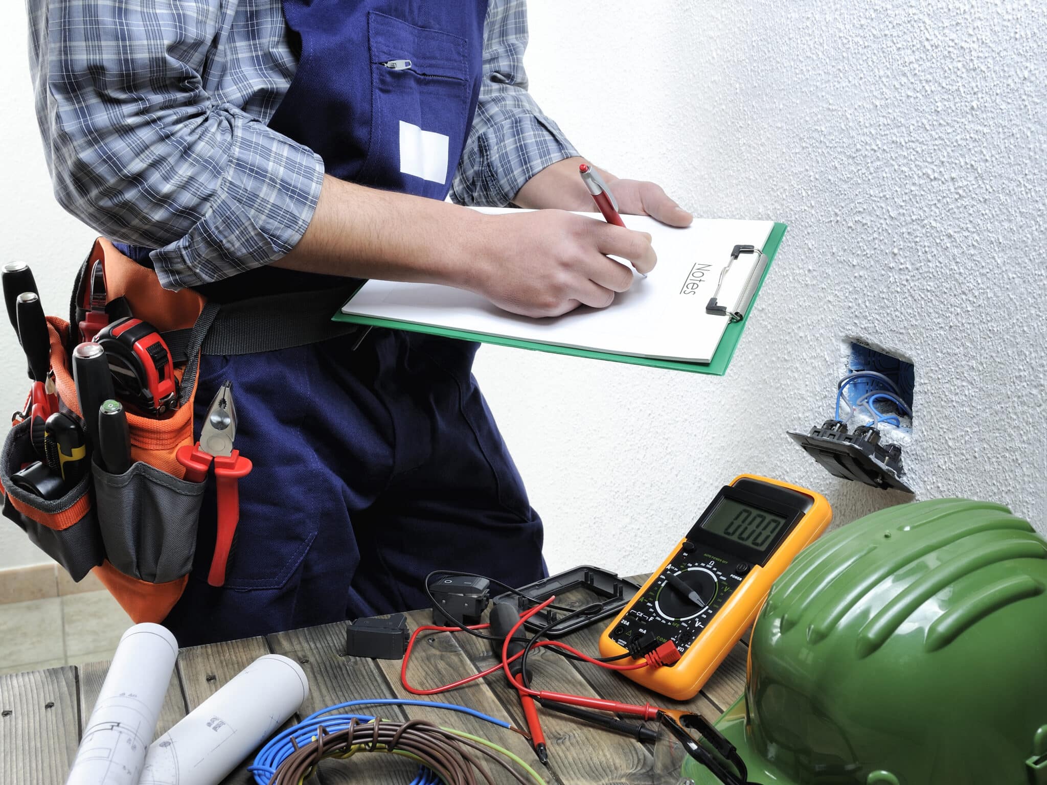 Electrician with tools and checklist