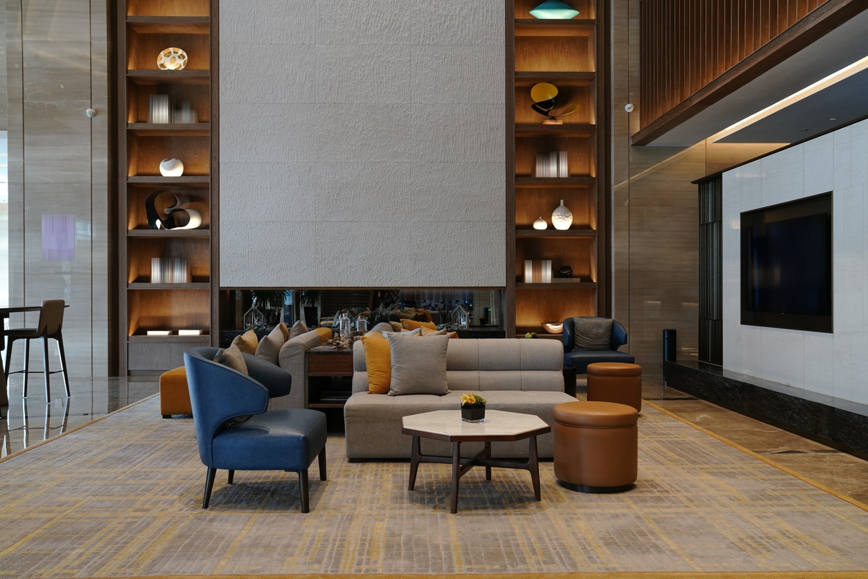 Hotel lobby with lighted shelves and recessed lighting