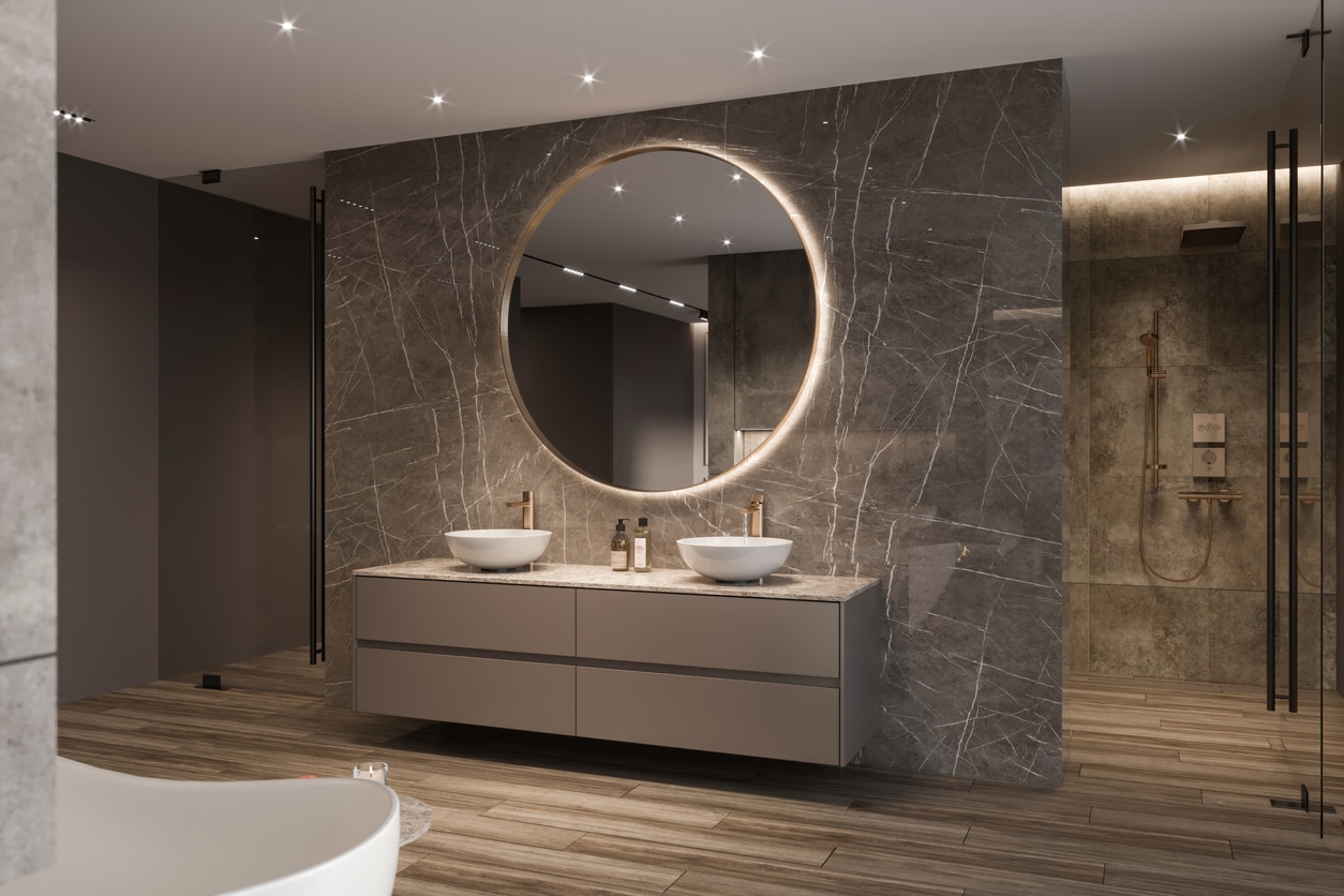 Modern bathroom with recessed lights and a lighted mirror